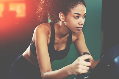 woman getting a total body workout on exercise bike