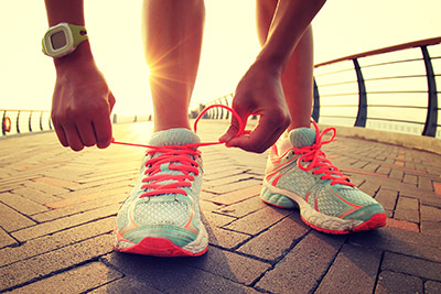 Woman tying running shoe