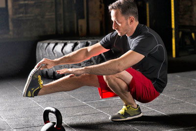 Man doing pistol squat at a gym