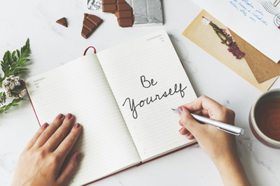 woman writing positive affirmations