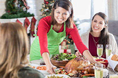 woman serves holiday meal