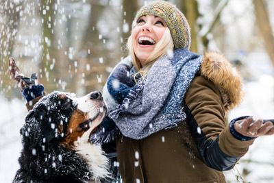 woman with a dog in the snow